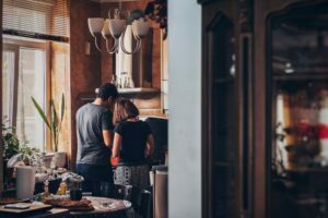 a group of people standing in a kitchen