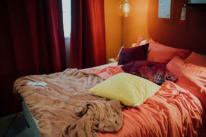 a bed with a red blanket