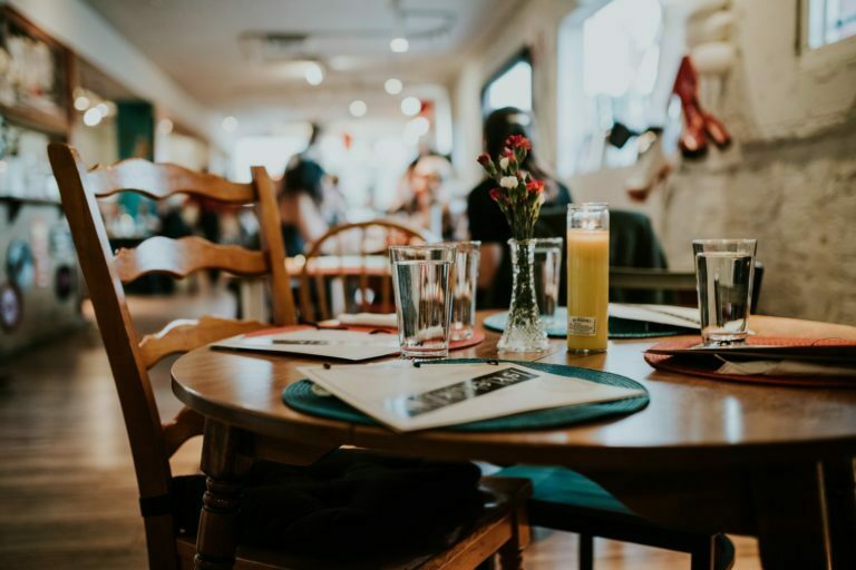a table with glasses and a menu