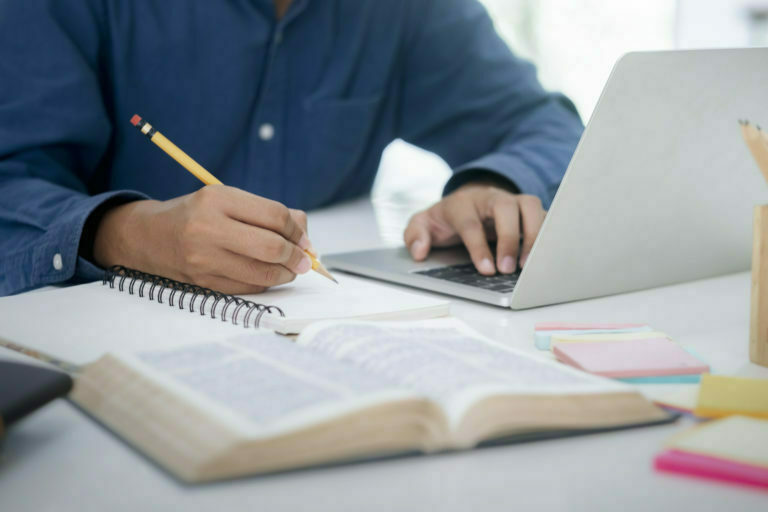 a person writing on a book