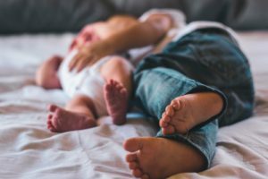 a baby sleeping on a bed