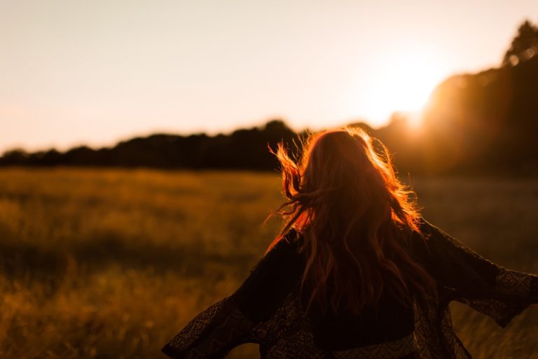 a person holding their hair up