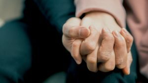 a close-up of a person holding the hands together