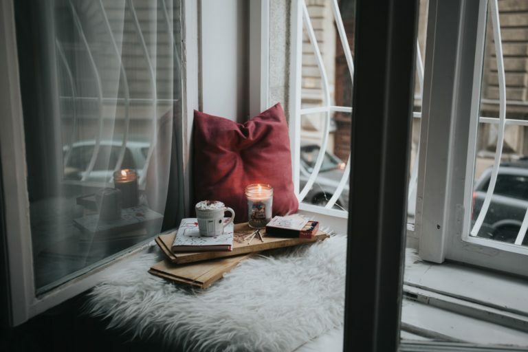 a table with a book and a red hat on it