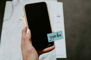 a hand holding a cell phone