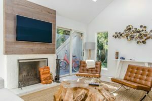 a living room with a tv and fireplace