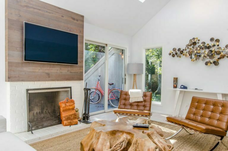 a living room with a tv and fireplace