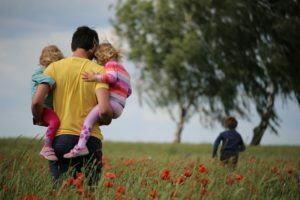 a group of people standing in a field of flowers