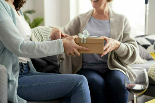 a woman holding a box of food