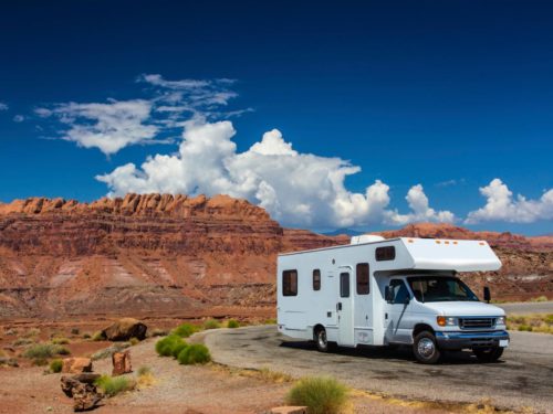 a white rv parked in a desert