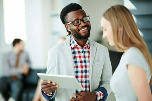 a man and woman looking at a paper
