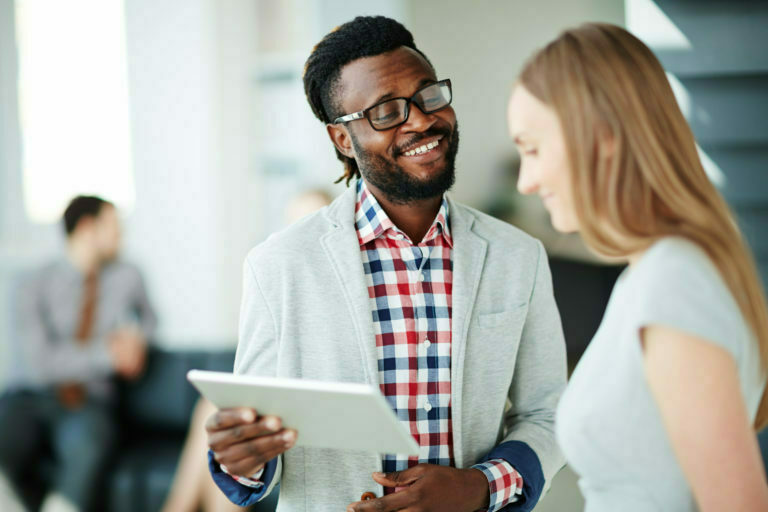 a man and woman looking at a paper