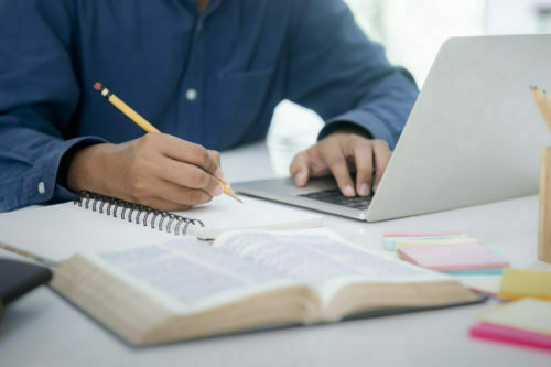a person writing on a book