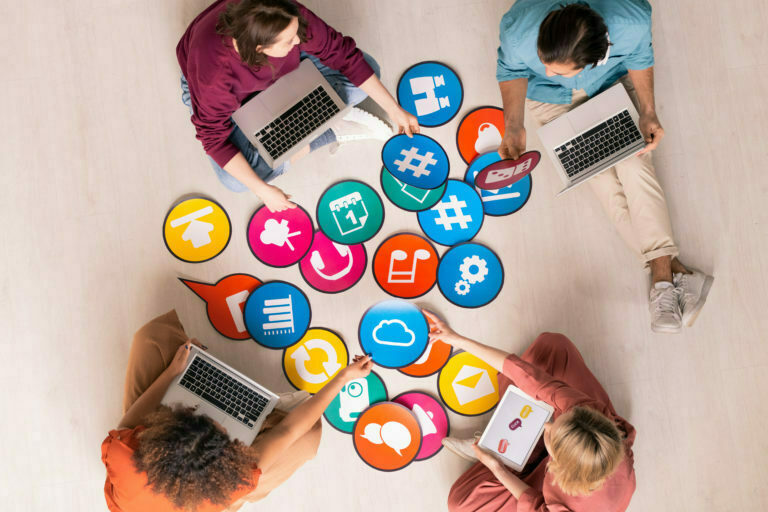 a group of kids playing with a laptop