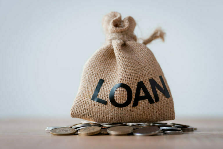 LOAN SACK ON A TABLE WITH COINS