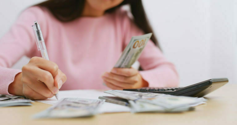 Woman counting the money at home