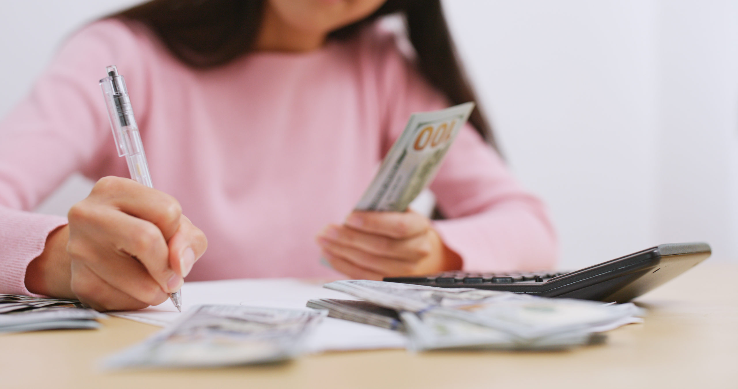 Woman counting the money at home