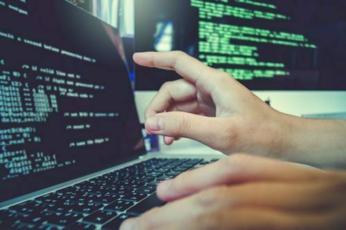 hands typing on a laptop